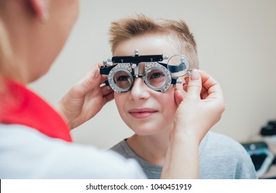 Trial frame. Glasses for a little boy. Hypermetropia. Ametropia correction with glasses.
