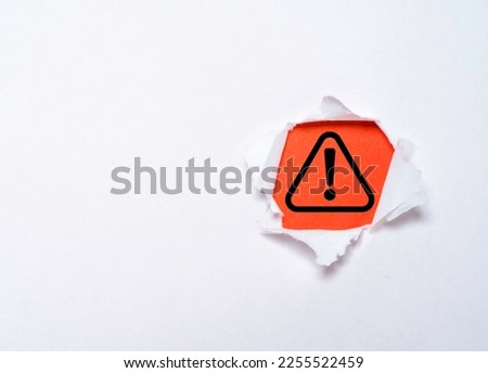 Triangle caution warning sign on red background inside f punched paper for notification error and need maintenance support concept.