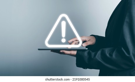 Triangle caution warning sing on tablet screen and Businessman using. Problem for notification error 404 and maintenance service alarm or beware hazard in internet network concept.