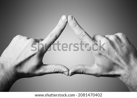 Triangle shape made with fingers. Two hands connected together background. Illuminati triangle. Fingers sign isolated on white.