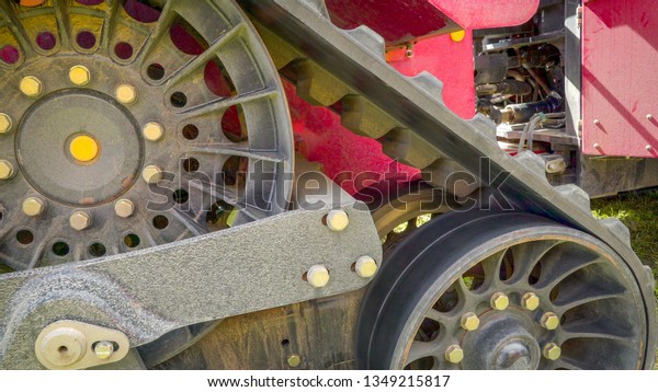 The triangle shape tire of the\
big harvester truck being displayed outside the bazaar\
event
