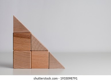 triangle of the wood blocks on the grey background with copy space