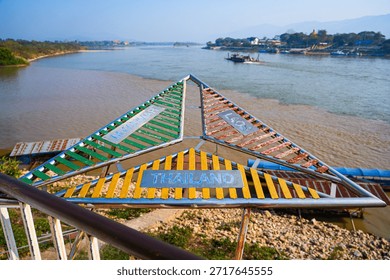 The triangular border marker at the confluence of the Mekong and Ruak rivers in the Golden Triangle Park (Sop Ruak) in Chiang Saen in Northern Thailand