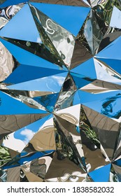 Triangular cone texture, blue mirror foil background with reflection. Geometric abstraction. Photography, concept.