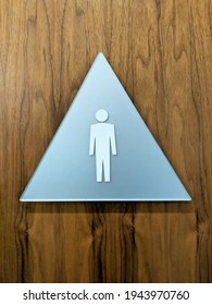 Triangular Mens Bathroom Sign On A Wood Door.