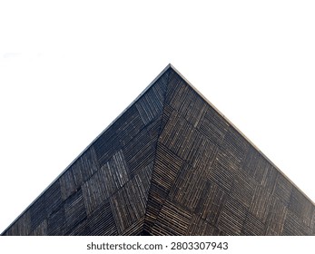 Triangular modern architecture facade made of patterned woven bamboo (Bambusoideae) on white background.