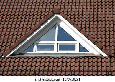 triangular plastic window on the roof with tiles