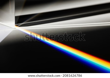 Triangular Prism dispersing sun beam splitting into a spectrum on white background , Rainbow