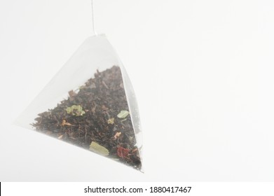 Triangular shape tea bag isolated on white studio background - Powered by Shutterstock