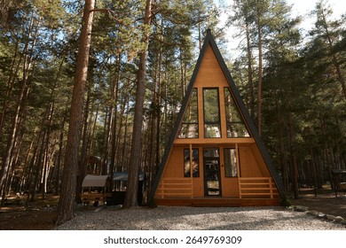 Triangular shaped chalet in a secluded location surrounded by mountain pines.                               