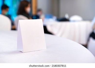 Triangular shaped table sign is placed on the table for scanning QR codes as an announcement, reservation sign, or menu at the seminar.