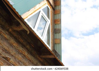 Triangular skylight of an attic of a village log house under construction against a cloudy sky - Powered by Shutterstock - Get 15% off with code: PIKWIZARD15