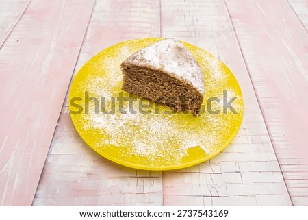  a triangular slice of carrot cake served with elegant decoration, a rosette of extra cream cheese frosting, a sprig of mint, and a drizzle of salted caramel around the edge of the plate.