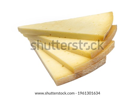Triangular slice of old cheddar cheese. Piece of yellow cheese with sliced pieces on white background.
