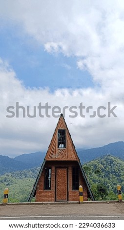 Triangular wooden house in the middle of a vegetable plantation for copy space of story