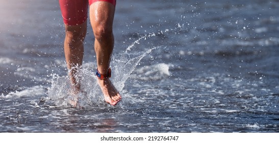 Triathlete Swimmer Running Out Of Ocean Finishing Swim Race. Fit Man Ending Swimming Sprinting Determined Out Of Water