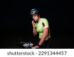 A triathlete using a smartphone while taking a break from a hard night