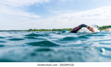 Triathlete In A Wetsuit Swims In A Lake At A Triathlon Competition