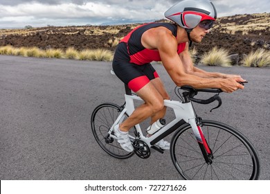 Triathlon Biking Cyclist Man Triathlete Riding Racing Bike During Ironman Competition. Road Cycling Athlete In Tri Suit And Helmet.