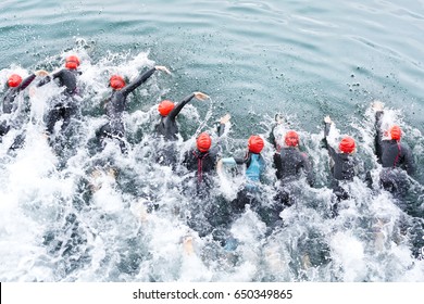  Triathlon Competitors In Swim , Triathletes In Action And Motion