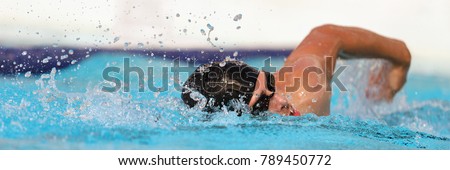 Triathlon fitness athlete training swimming in wave pool at gym health centre. Swimmer man swmming in blue water banner panorama. Sport and fitness cardio exercise.
