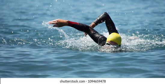 Triathlon Long Distance Swimming, People In Wetsuit Swimming At Triathlon