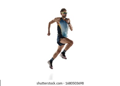 Triathlon male athlete running isolated on white studio background. Caucasian fit jogger, triathlete training wearing sports equipment. Concept of healthy lifestyle, sport, action, motion. Side view. - Shutterstock ID 1680503698