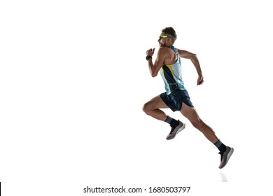 Triathlon male athlete running isolated on white studio background. Caucasian fit jogger, triathlete training wearing sports equipment. Concept of healthy lifestyle, sport, action, motion. In jump.