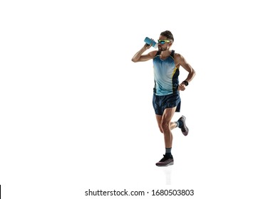 Triathlon male athlete running isolated on white studio background. Caucasian fit jogger, triathlete training wearing sports equipment. Concept of healthy lifestyle, sport, action, motion. Drinks - Shutterstock ID 1680503803