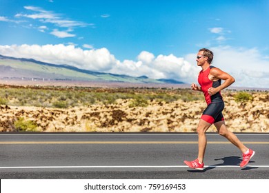 Triathlon Runner Triathlete Man Running In Tri Suit At Ironman Competition Race On Road. Sport Athlete On Marathon Run Training Exercising Cardio In Professional Outfit For Triathlon. Fitness Hawaii.