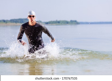 Triathlon Swimmer Splashing Around While Running Out Of Water