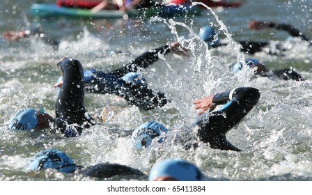 Triathlon Swimmers Churning Up The Water.