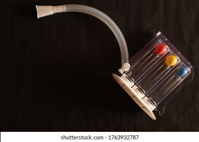 Triball incentive spirometer threeflow respiratory exerciser for breathing exercise for lung fitness isolated on black background with copy space. - Shutterstock ID 1763932787