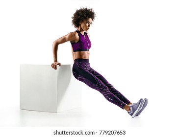 Triceps dips. Sporty girl doing exercises for triceps on white background. Fitness and healthy lifestyle concept
