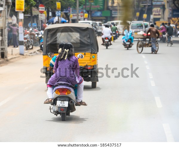 TRICHY, INDIA - FEBRUARY 15: An unidentified Indian\
riders ride motorbikes on rural road. India, Tamil Nadu, near\
Trichy. February 15,\
2013