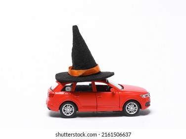 Trick Or Treat. Halloween Concept. Toy Car Model With Witch Hat Isolated On White Background