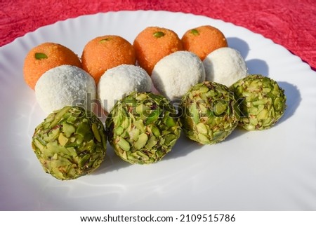 Tricolor Tiranga sweets Ladoo or Laddu for Indian Republic day and Independence day , served in ceramic plate. Close up of Indian flag three colours food celebration