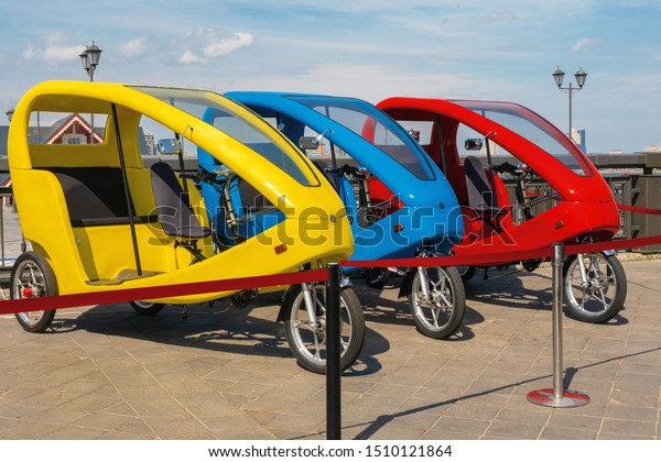Tricycle transportation for sightseeing tours.\
Fiets Taxi or bicycle taxi. Tuk tuk small passenger three weel mini\
car. Kazan, Russia,\
09.07.2019