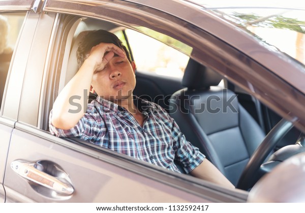 Tried man sleep in car at car park during\
wait someone in business or shopping\
time.