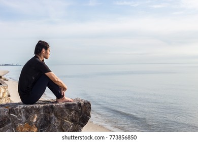 Tried and stressed woman sitting on the beach