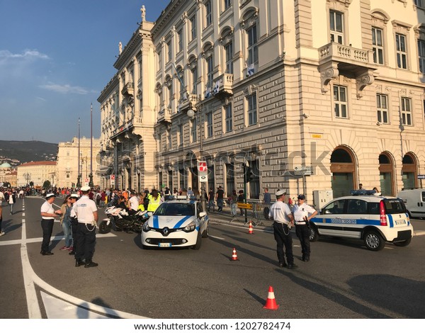 TRIESTE, ITALY - OCTOBER 14, 2018: Closed centre\
street in Trieste at Barcolana regatta - a historic international\
sailing regatta taking place every year in the Gulf of Trieste.\
Police cars on street