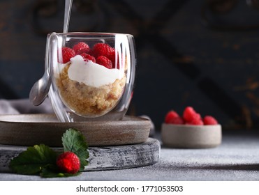 Trifle dessert with fresh raspberries in a glass - Shutterstock ID 1771053503