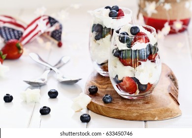 Trifle Made With Blueberries, Strawberries, Whipped Cream And Star Shaped Pound Cake Sitting On A Fourth Of July Picnic Table. Shallow Depth Of Field With Selective Focus.