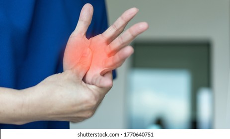 Trigger Finger problems. Woman’s hand with red spot o fingers as suffer from Carpal tunnel syndrome. The symptoms of tingling, numbness, weakness, or pain of the fingers and wrist.