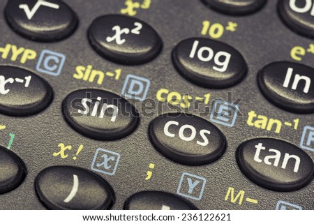 trigonometry functions push buttons of scientific calculator with focus on cos button