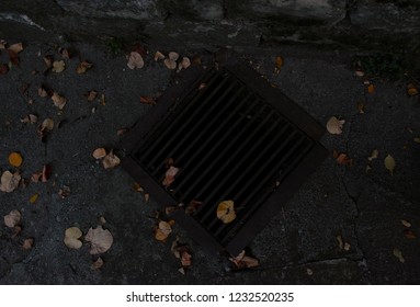 TRIKALA, GREECE- NOVEMBER 3, 2018: An Old Storm Drain As Seen From Above With Leaves Scattered. It Is Right Next To The Road.