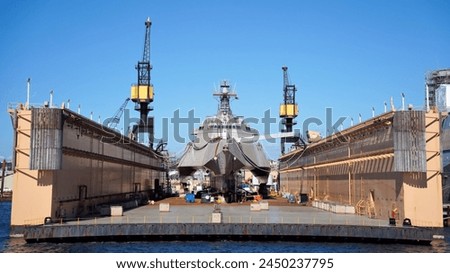 A Trimaran Ship Recieving Maintenance in a Floating Drydock at a Shipyard