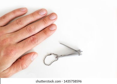 Trimmed nails of a young man. Manicures for men himself. On white background. Short fingernails. Hands. Close up.