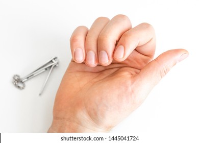 Trimmed Nails Of A Young Man. Manicures For Men Himself. On White Background. Short Fingernails. Hands. Close Up.