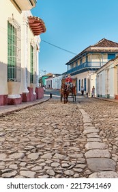 Trinidad, Cuba - February 12, 2022: Cobblestone Street In Colonial Old Town. Cabman On Horse-drawn Cart. Transport, Travel Concept.